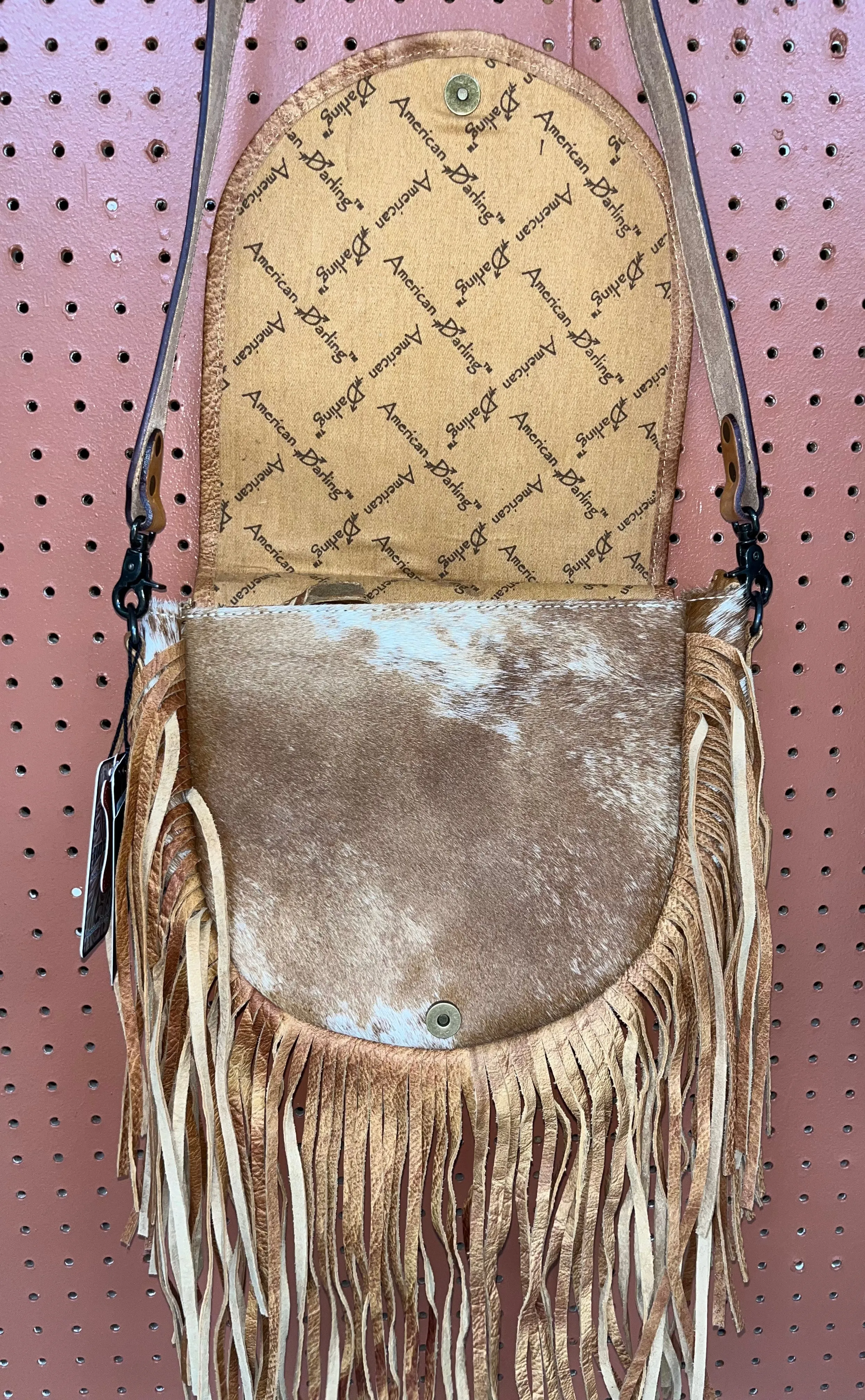 Rounded cowhide and leather crossbody